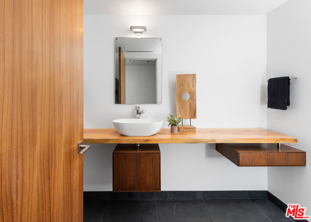 3431 Coast View Drive Malibu, CA 90265 - Photo 26 of 49 a bathroom with a sink and a mirror