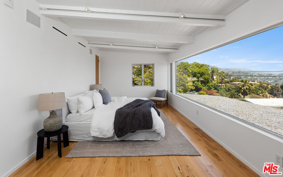 3431 Coast View Drive Malibu, CA 90265 - Photo 27 of 49 a bedroom with a bed and window