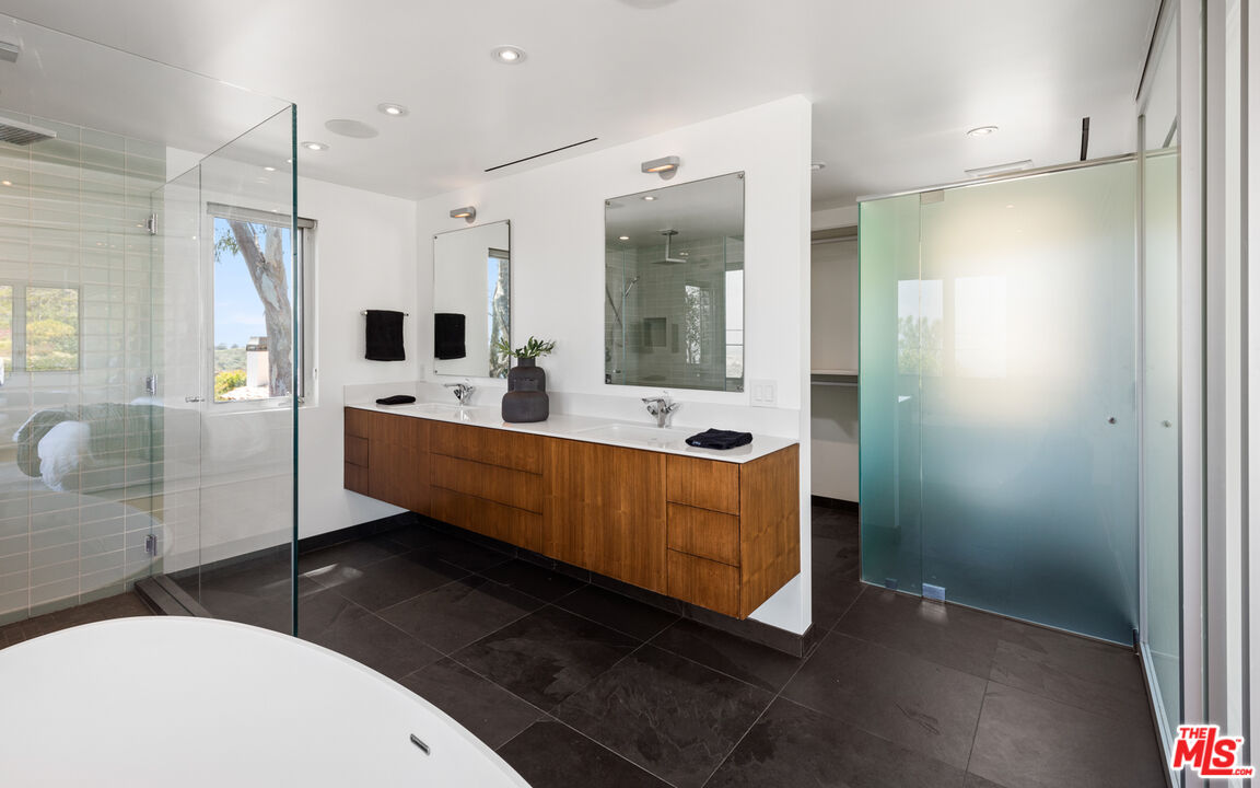 3431 Coast View Drive Malibu, CA 90265 - Photo 31 of 49 a bathroom with a tub mirror and sink