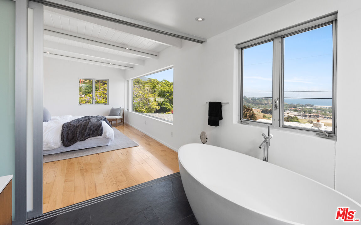 3431 Coast View Drive Malibu, CA 90265 - Photo 32 of 49 a living room with a bed furniture and a large window