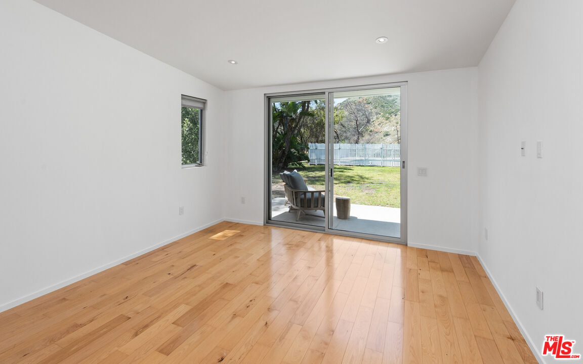 3431 Coast View Drive Malibu, CA 90265 - Photo 33 of 49 a view of a room with wooden floor and a window