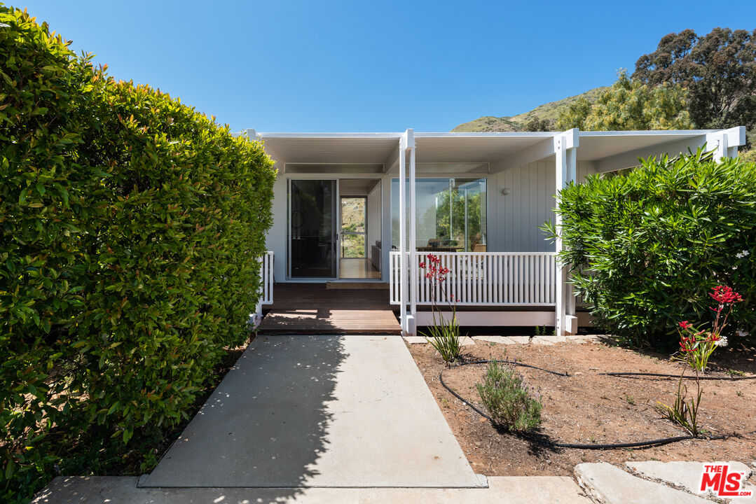 3431 Coast View Drive Malibu, CA 90265 - Photo 39 of 49 a view of a house with a small yard and potted plants