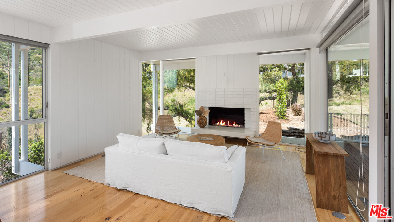 3431 Coast View Drive Malibu, CA 90265 - Photo 40 of 49 a living room with furniture and a fireplace