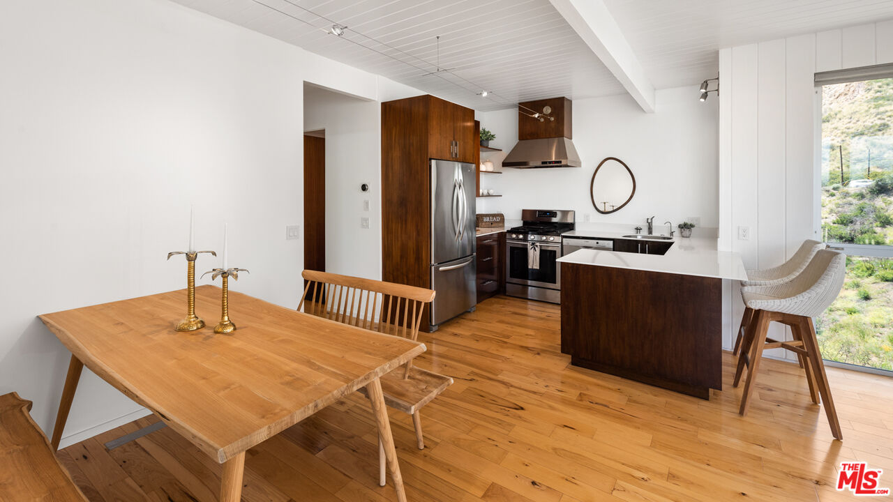 3431 Coast View Drive Malibu, CA 90265 - Photo 42 of 49 a room with a table chairs and a stove