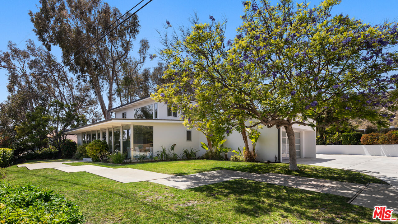 3431 Coast View Drive Malibu, CA 90265 - Photo 7 of 49 a front view of a house with a yard and garage