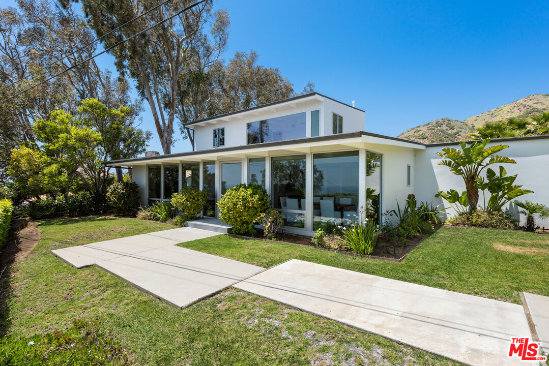 3431 Coast View Drive Malibu, CA 90265 - Photo 8 of 49 a view of a house with backyard sitting area and garden