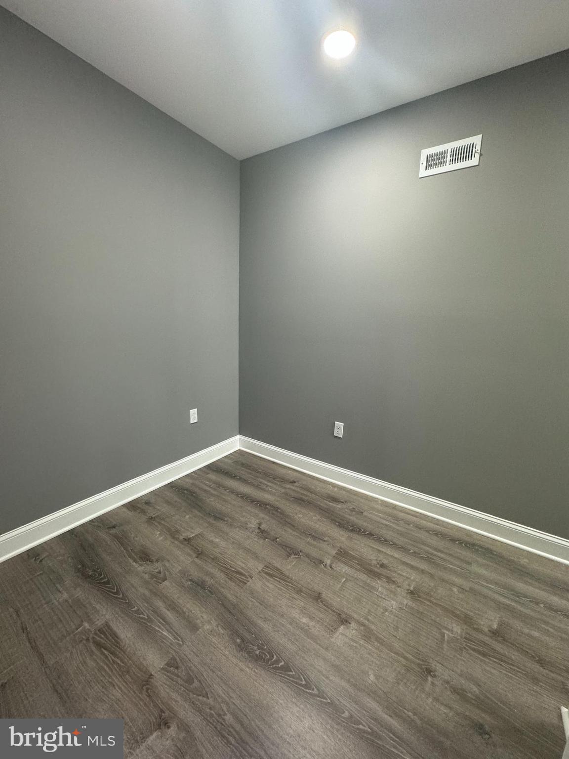 1722 South Taylor Street Philadelphia, PA 19145 - Photo 9 of 15 an empty room with wooden floor and windows