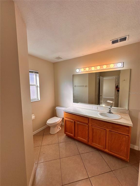 639 Cheshire Way Davenport, FL 33897 - Photo 12 of 15 a bathroom with a double vanity sink and a mirror