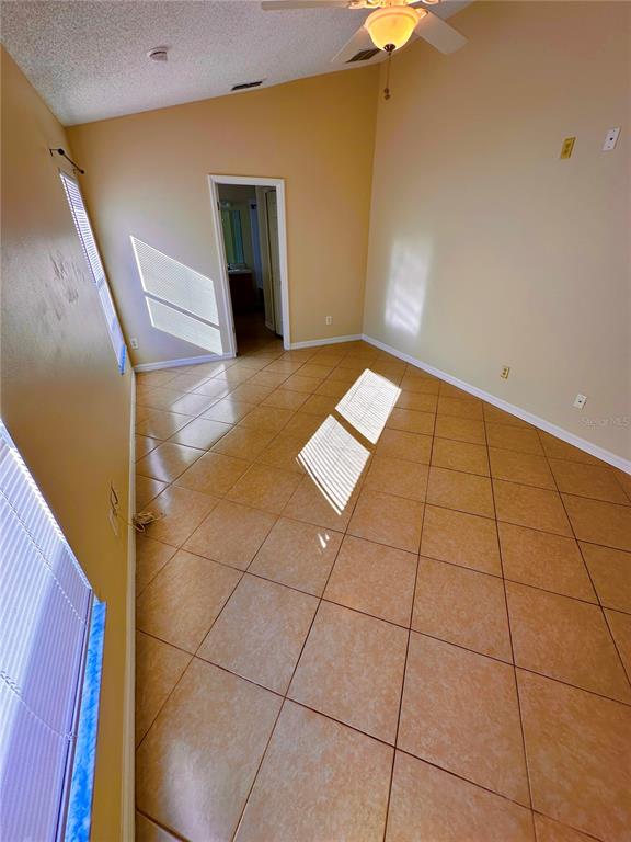 639 Cheshire Way Davenport, FL 33897 - Photo 13 of 15 a view of a livingroom with an empty space and a staircase