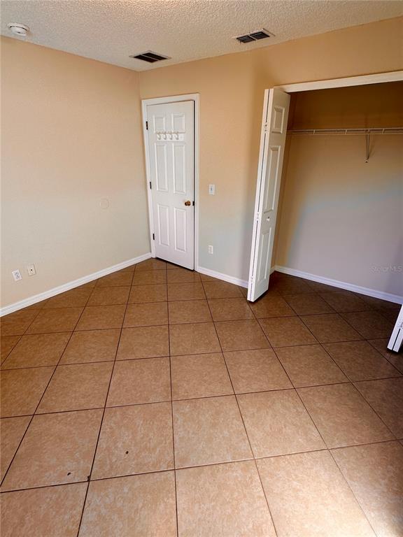 639 Cheshire Way Davenport, FL 33897 - Photo 6 of 15 a view of an empty room with wooden floor
