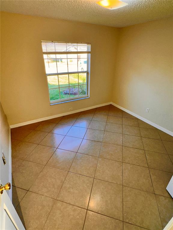 639 Cheshire Way Davenport, FL 33897 - Photo 10 of 15 a view of an empty room and window