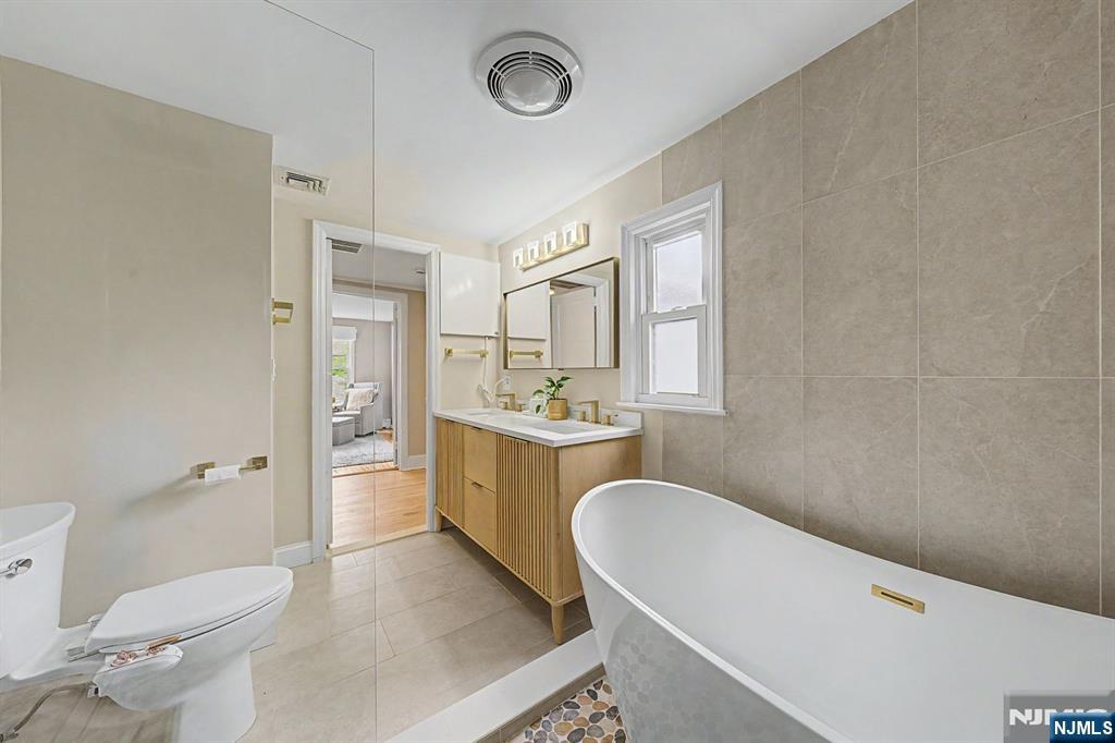 45 Highfield Road Bloomfield, NJ 07003 - Photo 30 of 50 a bathroom with a sink a toilet a mirror and shower