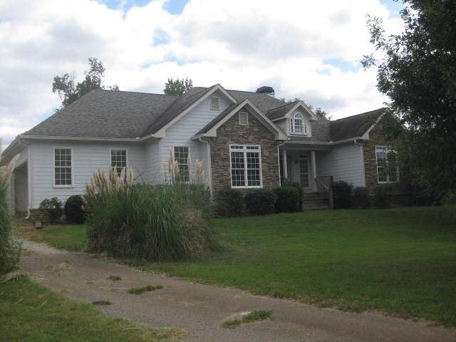 172 Brickyard Road Comer, GA 30629 - Photo 1 of 1 a view of a yard in front of a house with plants and large trees
