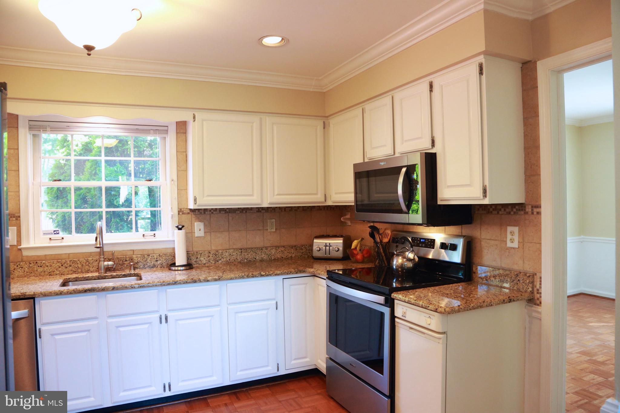 213 Ravenwood Road Exton, PA 19341 - Photo 14 of 56 see the in-ground pool from the kitchen