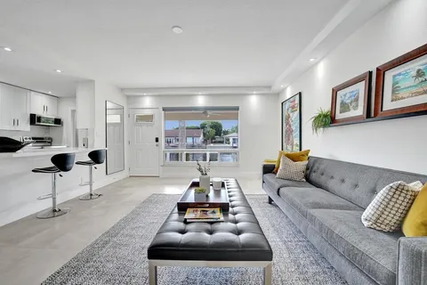 a living room with furniture and a potted plant