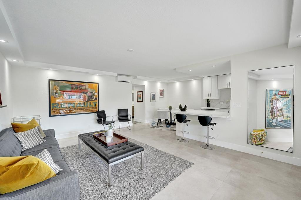 2866 Northeast 30th Street, Unit 9 Fort Lauderdale, FL 33306 - Photo 14 of 54 a living room with furniture and a flat screen tv