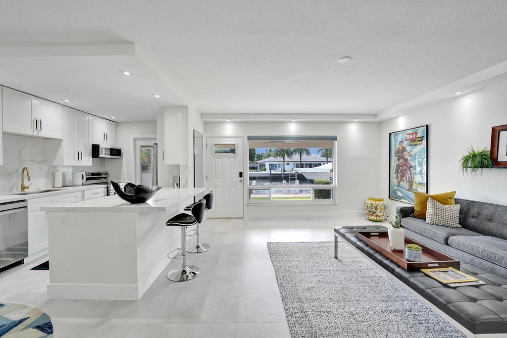 2866 Northeast 30th Street, Unit 9 Fort Lauderdale, FL 33306 - Photo 18 of 54 a living room with furniture and a table