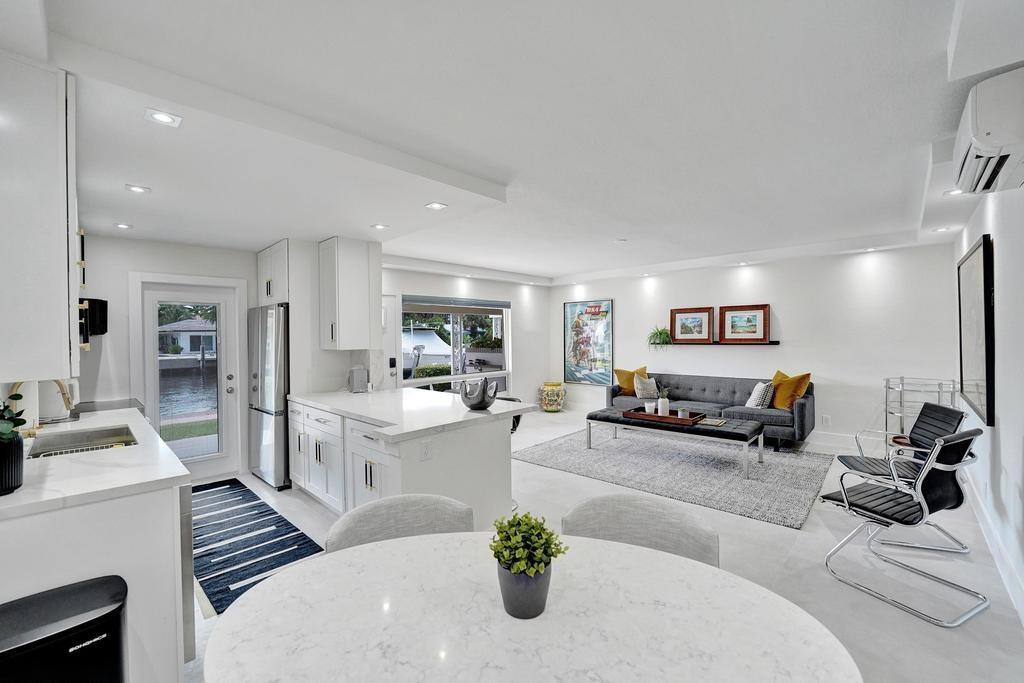 2866 Northeast 30th Street, Unit 9 Fort Lauderdale, FL 33306 - Photo 19 of 54 a living room with furniture and a flat screen tv