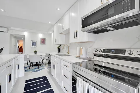 a bedroom with a large bed and a potted plant