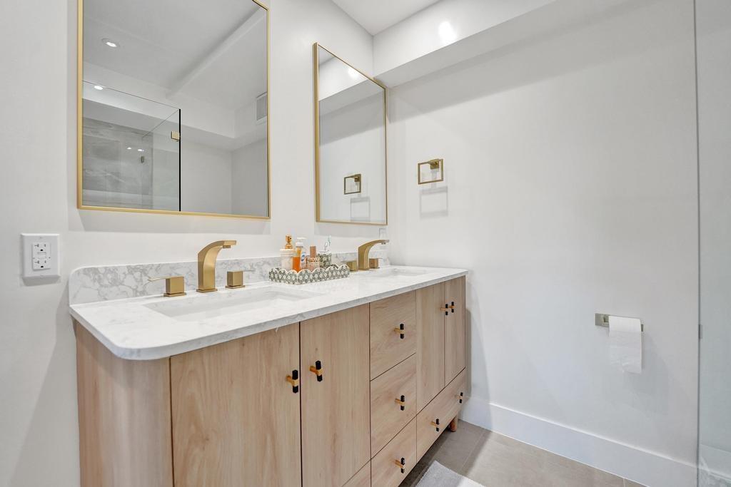 2866 Northeast 30th Street, Unit 9 Fort Lauderdale, FL 33306 - Photo 26 of 54 a bathroom with a sink a vanity and a mirror