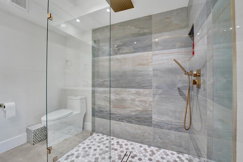 2866 Northeast 30th Street, Unit 9 Fort Lauderdale, FL 33306 - Photo 27 of 54 a bathroom with a shower and a toilet