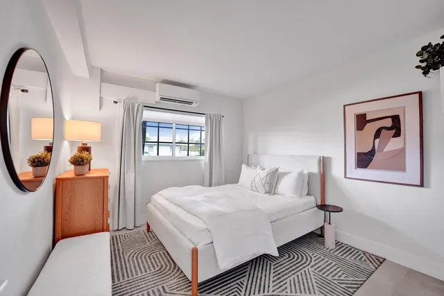 a bedroom with a bed and a mirror