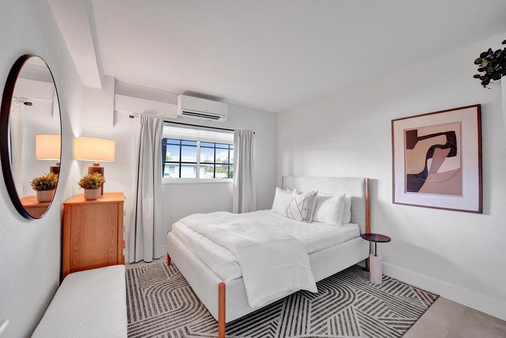 2866 Northeast 30th Street, Unit 9 Fort Lauderdale, FL 33306 - Photo 29 of 54 a bedroom with a large bed and a mirror