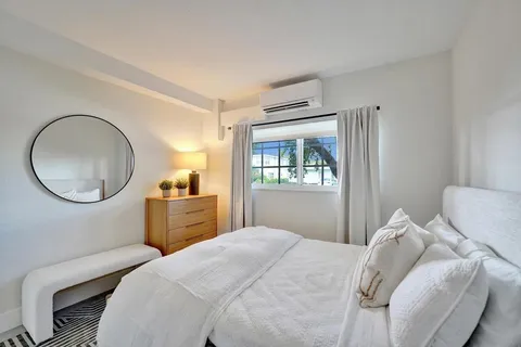 a large white bed in a white room
