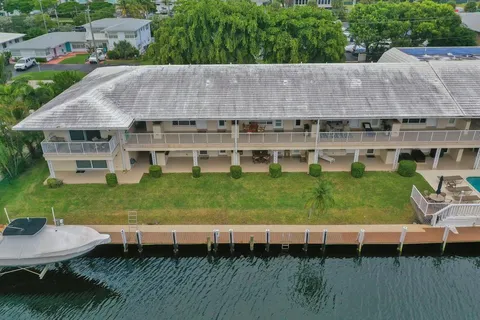 a aerial view of a house with a yard and a patio