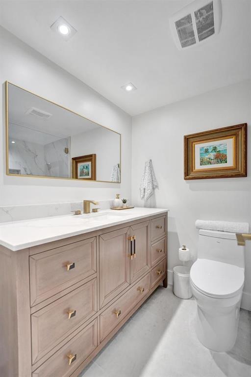2866 Northeast 30th Street, Unit 9 Fort Lauderdale, FL 33306 - Photo 33 of 54 a spacious bathroom with a toilet sink double vanity and mirror