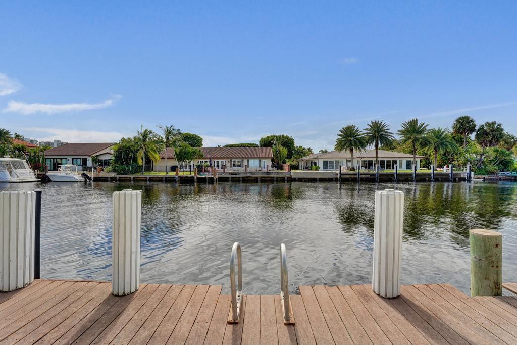 2866 Northeast 30th Street, Unit 9 Fort Lauderdale, FL 33306 - Photo 6 of 54 a view of a lake with boats and palm trees