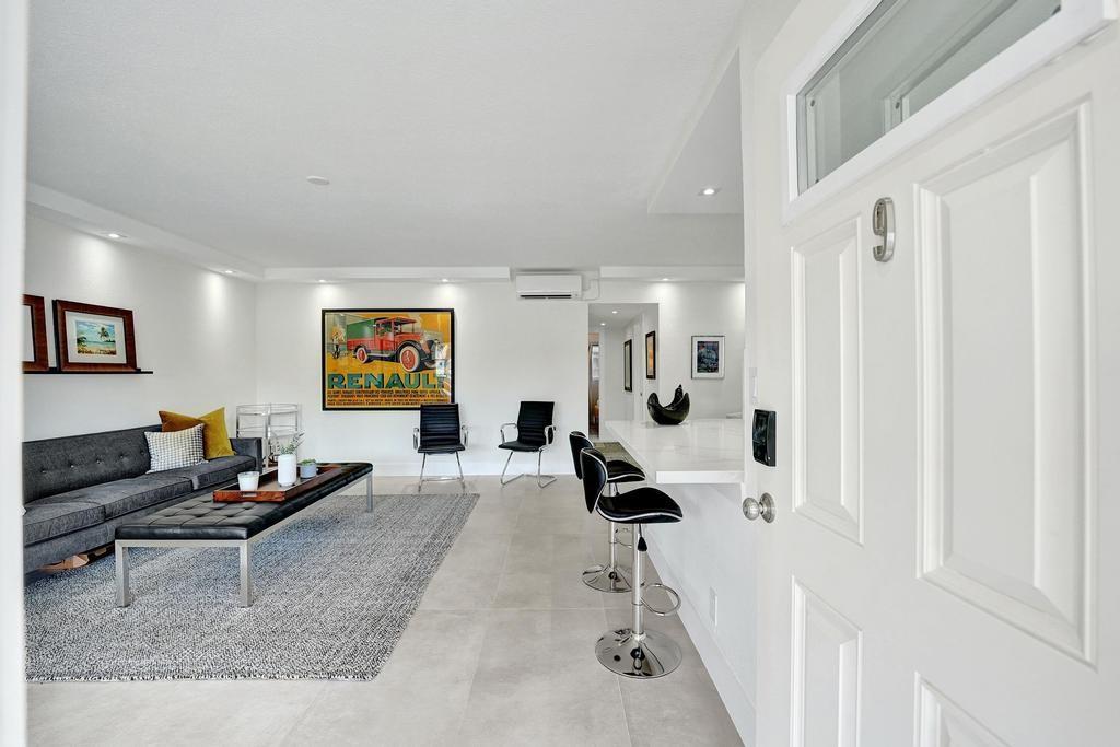 2866 Northeast 30th Street, Unit 9 Fort Lauderdale, FL 33306 - Photo 7 of 54 a living room with furniture and a rug