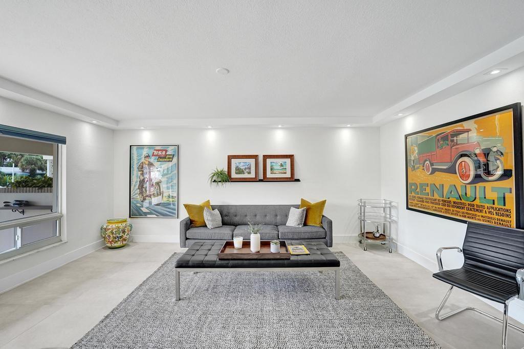 2866 Northeast 30th Street, Unit 9 Fort Lauderdale, FL 33306 - Photo 9 of 54 a living room with furniture and a painting on the wall