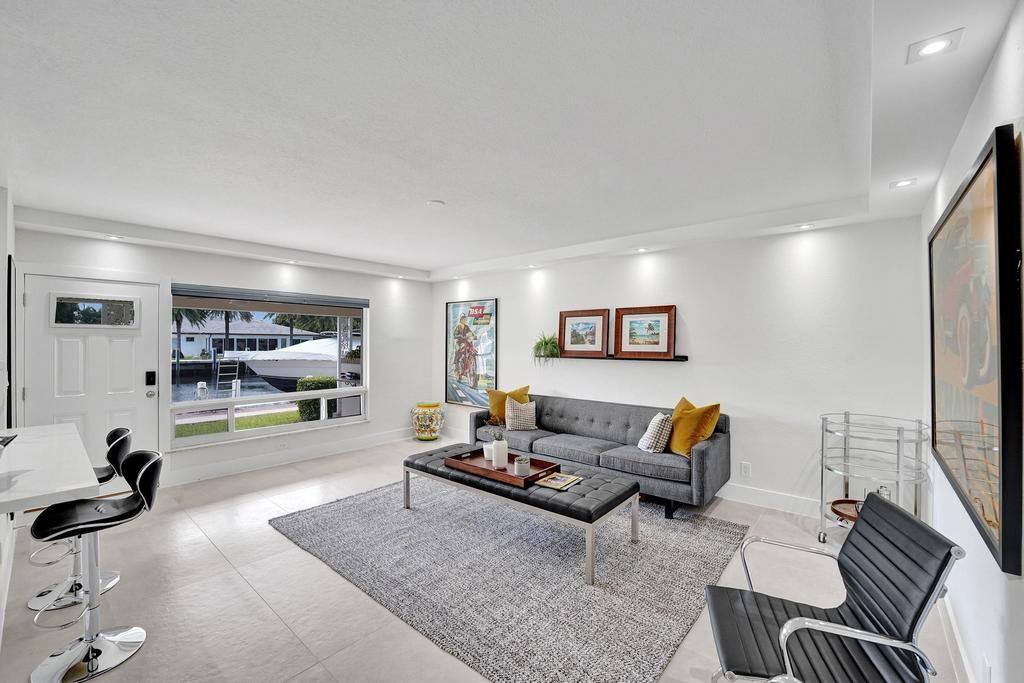 2866 Northeast 30th Street, Unit 9 Fort Lauderdale, FL 33306 - Photo 10 of 54 a living room with furniture a flat screen tv and a large window
