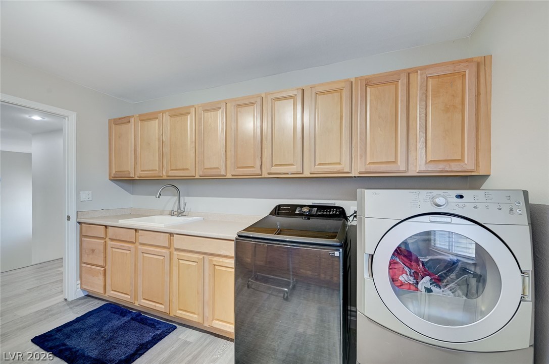 2391 Rainswept Avenue Henderson, NV 89052 - Photo 54 of 62 This functional laundry area features ample cabinetry and modern appliances for everyday convenience.