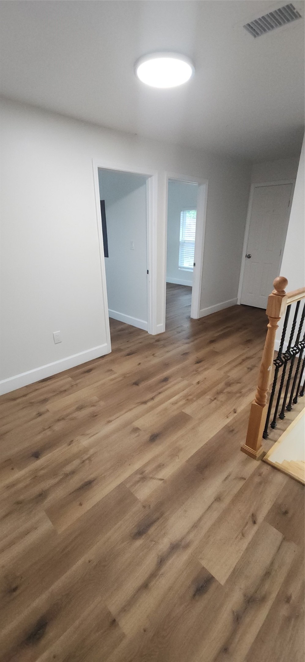 2304 Chapman Street, Unit 3 Houston, TX 77009 - Photo 8 of 17 an empty room with wooden floor and windows
