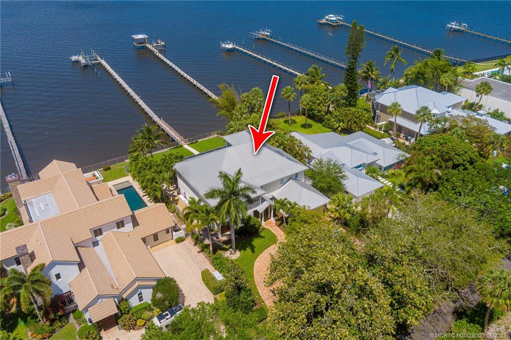 1455 Southeast Riverside Drive Stuart, FL 34996 - Photo 33 of 100 an aerial view of a house with a yard and potted plants