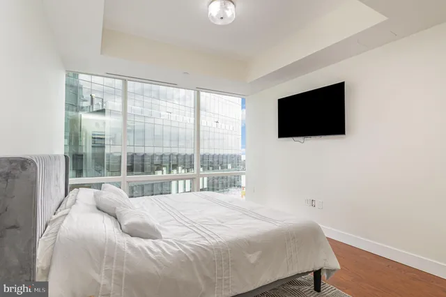 a bedroom with a bed and a flat screen tv