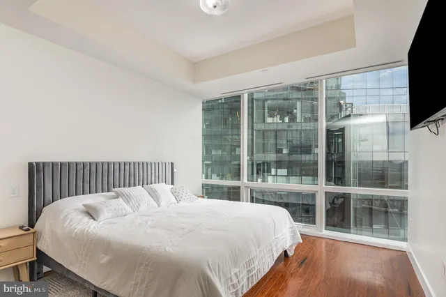 a large bed sitting in a bedroom next to a large window
