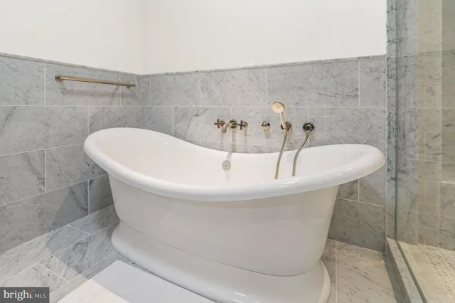 a white bath tub sitting in a bathroom