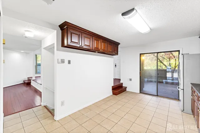 a view of a hallway with closet and a chandelier fan