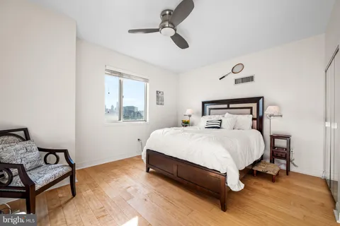 a bedroom with a bed a desk and chair