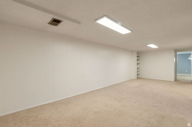 447 550 South Bountiful, UT 84010 - Photo 17 of 25 Expansive room featuring light-toned carpeting and vertical paneling