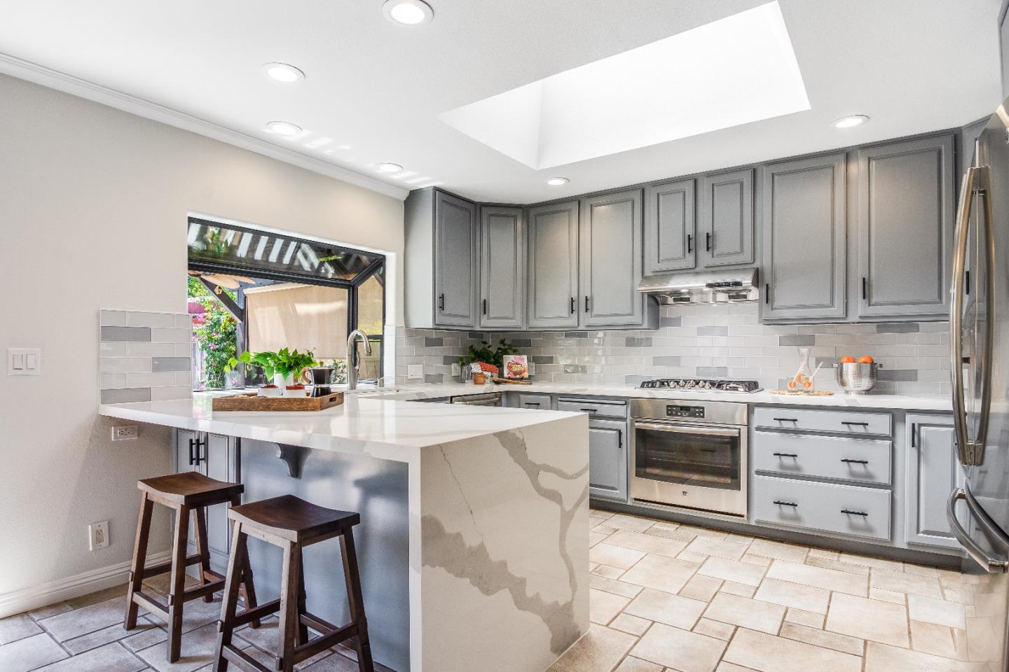 1674 Milroy Place San Jose, CA 95124 - Photo 3 of 12 a kitchen with stainless steel appliances granite countertop a stove top oven a sink dishwasher and white cabinets with wooden floor