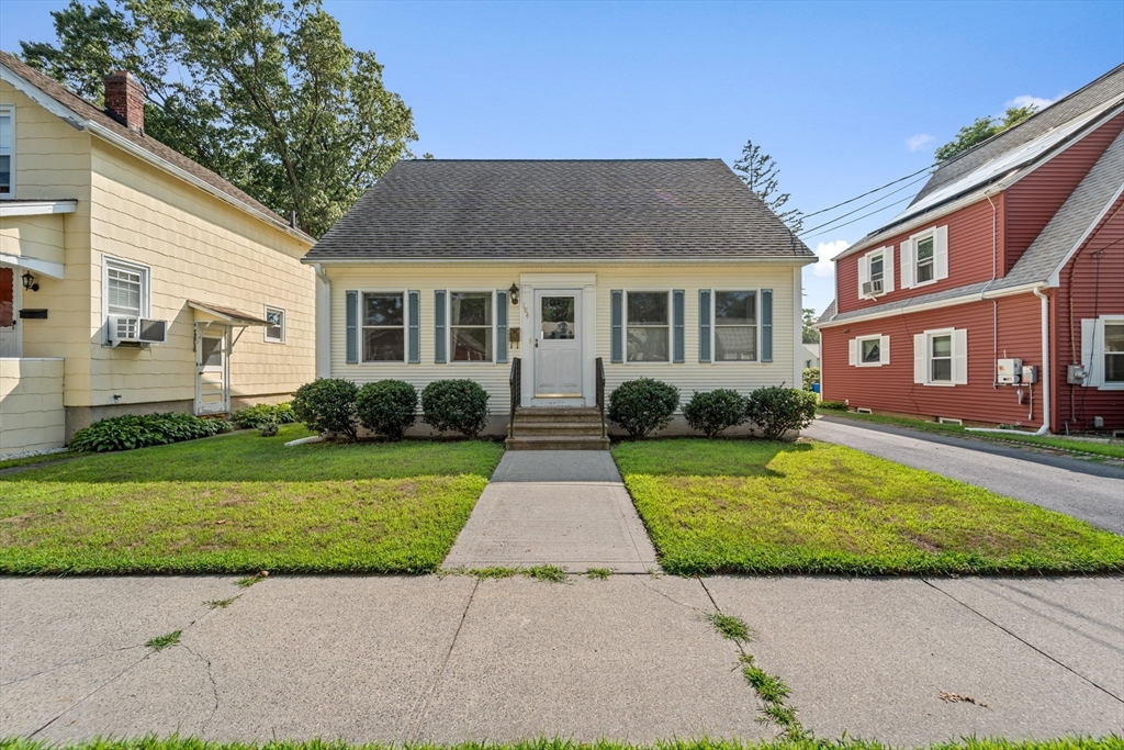 a front view of a house with a garden