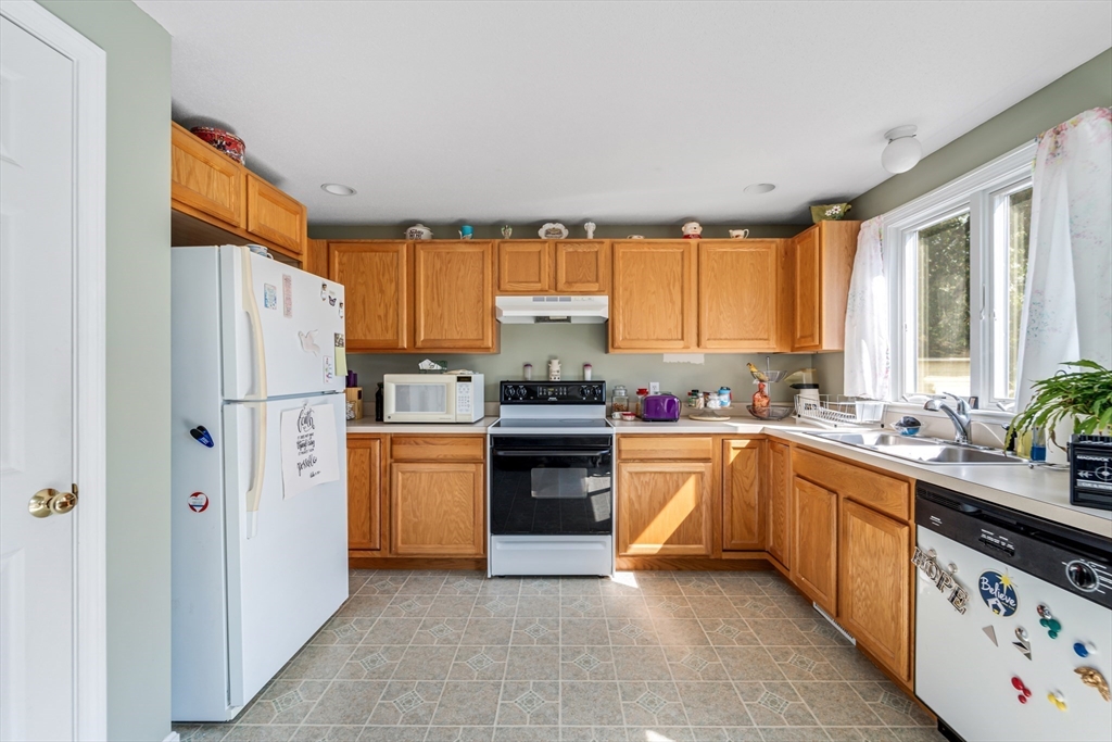 184 Russell Street Springfield, MA 01104 - Photo 4 of 28 a kitchen with stainless steel appliances granite countertop a refrigerator and a stove top oven