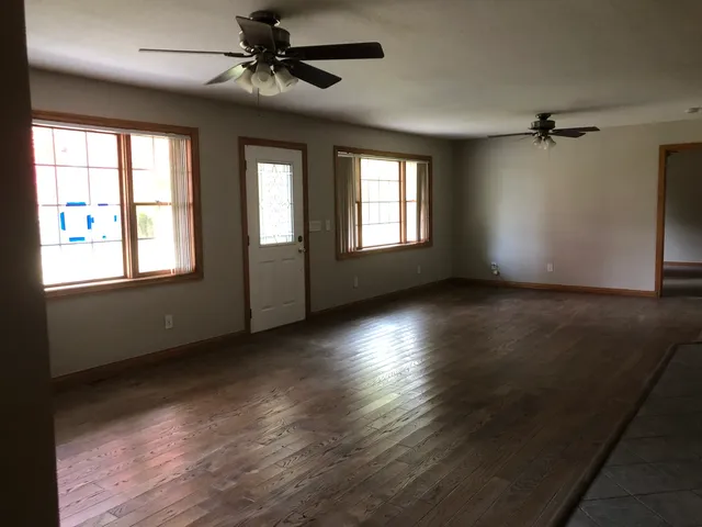 a view of a livingroom with a ceiling fan and window