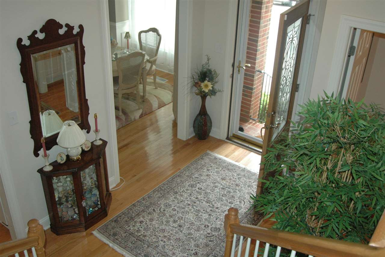 7316 Fontana Ridge Lane Raleigh, NC 27613 - Photo 8 of 20 Entrance foyer is super bright, hardwoods shine like new, seller also added a very nice storm door that she keeps open most of the time foyer