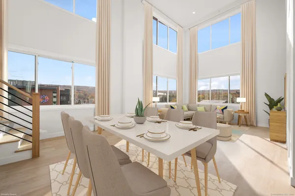 a view of a dining room with furniture window and wooden floor