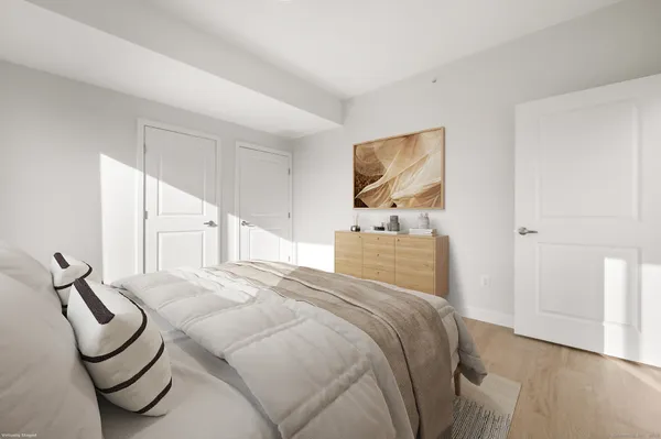a bedroom with a bed a couch and dresser
